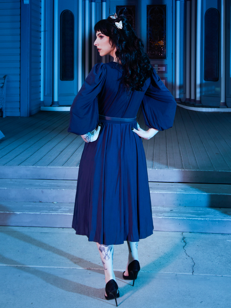The back of the Salem Dress in Navy being modeled by a female model.