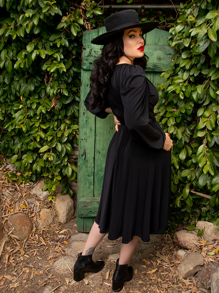 Backshot of Micheline Pitt wearing the Salem Dress in Black from gothic vintage clothing maker La Femme en Noir.