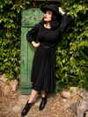 Micheline Pitt poses in her black goth dress from La Femme en Noir.