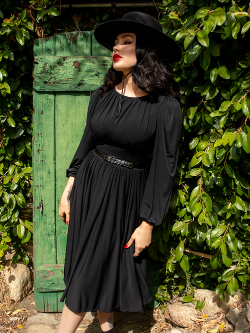In her black sunhat, Micheline Pitt wears the Salem Dress in Black.