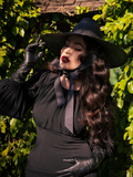 Micheline Pitt showing off an all-black outfit including the Salem Top in Black - all items from gothic retro style clothing company La Femme en Noir.