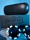 Gothic glamour clothing brand La Femme en Noir releases the BEETLEJUICE™ Sandworm Spectacles photographed along with the carrying case and retail box.