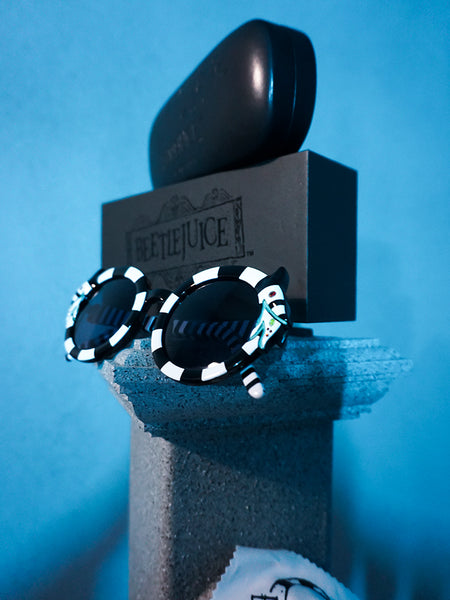 Isolated shot of the BEETLEJUICE™ Sandworm Spectacles on a stone pedestal. 