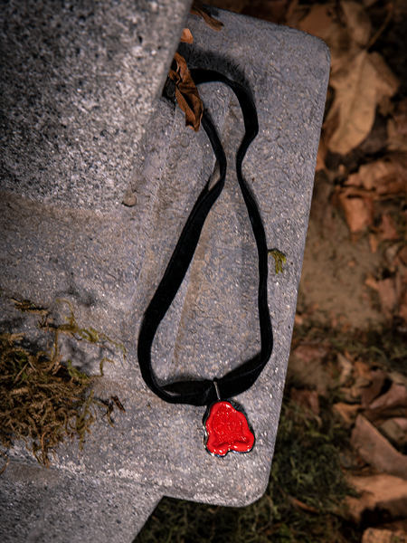 A closeup of the Sleepy Hollow™ Van Garrett Wax Seal Necklace by La Femme En Noir