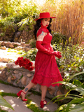 Micheline Pitt pulling on her crimson red gloves that match her goth skirt, top, shoes and hat!