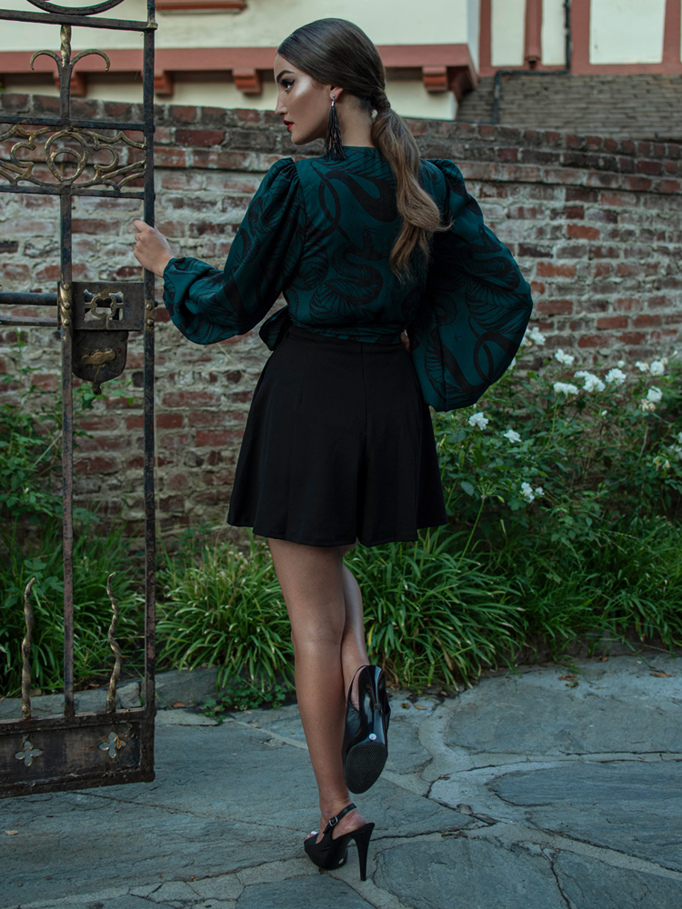 Aliza Schloesser showing off the back of her gothic style clothing outfit.