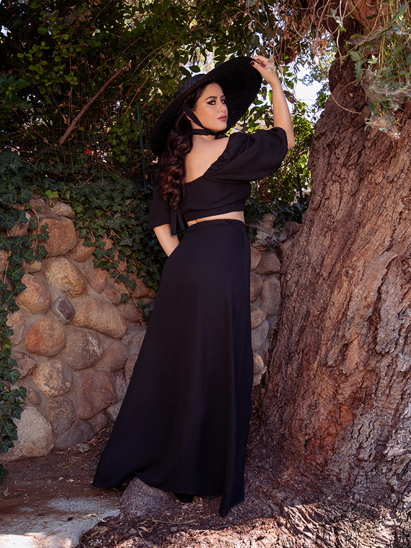 Ashley facing away from the camera shows off the back of the Thistle Two Piece Set in Black ChiffonThistle Two Piece Set in Black Chiffon.