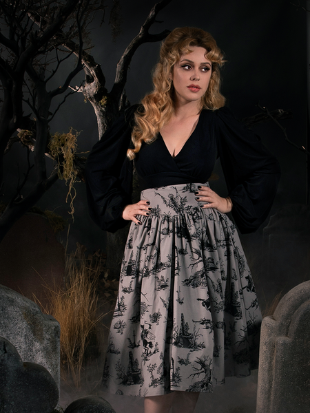 Linda standing in a spooky graveyard wearing the Sleepy Hollow Gothic Tales Toile Skirt in Grey. 