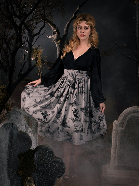 Linda pulling out the sides of her Sleepy Hollow Gothic Tales Toile Skirt in Grey to show off her gothic retro outfit.