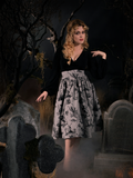 Linda posing while in the Sleepy Hollow Gothic Tales Toile Skirt in Grey.