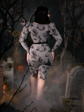 Rachel turned away from the camera to show off the back of the Sleepy Hollow Gothic Tales Toile Wiggle Dress in Grey from La Femme en Noir.