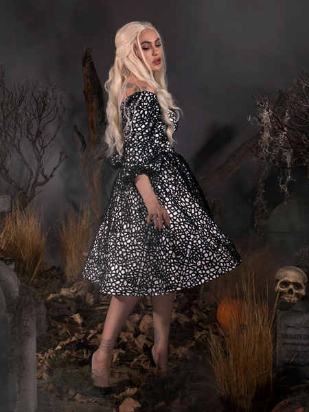 Twirling in a foggy cemetery, Micheline wears the Sleepy Hollow™ Lady Van Tassel Guipire Lace Dress by La Femme En Noir.