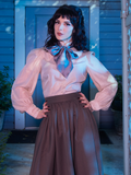 Stepanie poses with her arms resting on her hips while wearing the The Edwardian Blouse With Cravat.