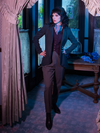 Stepanie looking off camera with her hands on her hips while wearing an outfit from gothic glamour clothing brand La Femme en Noir.