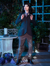 Full length shot of Stephanie pulling on the lapels of the Tim Burton's CORPSE BRIDE™ Victor Peplum Blazer in Spruce Green to show off her classic vintage goth look.