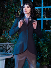 Stephanie pulls on the lapels of the Tim Burton's CORPSE BRIDE™ Victor Peplum Blazer in Spruce Green from gothic style clothing brand La Femme en Noir.
