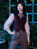 Stephanie stands in front of a green bush area while wearing the Tim Burton's CORPSE BRIDE™ Victor Vest in Vintage Brown from goth glamour clothing company La Femme en Noir.