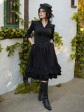 Model tucks her hands into the side pockets of the Victorian Dress in Black.