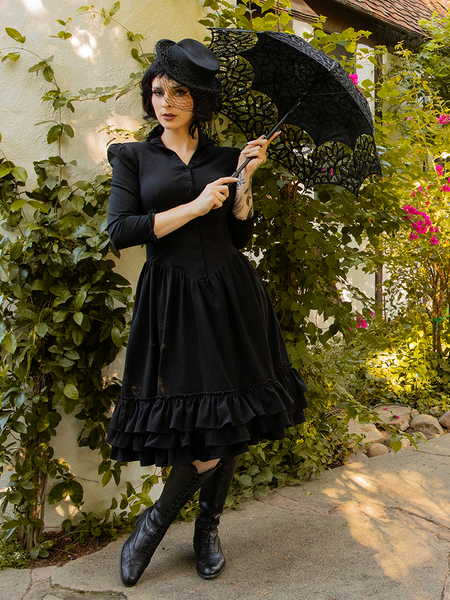 Goth glamour model wearing the Victorian Dress in Black from goth clothing brand La Femme en Noir.