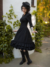 Model is photographed twirling while wearing the Victorian Dress in Black from La Femme en Noir.