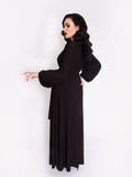Profile picture of Micheline Pitt wearing the Black Widow Wrap Gown in Solid Black.