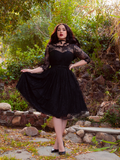 Pulling out the fabric on one side of her Mourning Dress in Black Lace, model Rachel Sedory shows off the intricate lace design of this gothic dress.