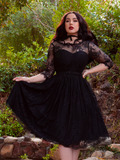Mourning Dress in Black Lace worn by model Rachel Sedory in a secluded and enchanted looking forest.